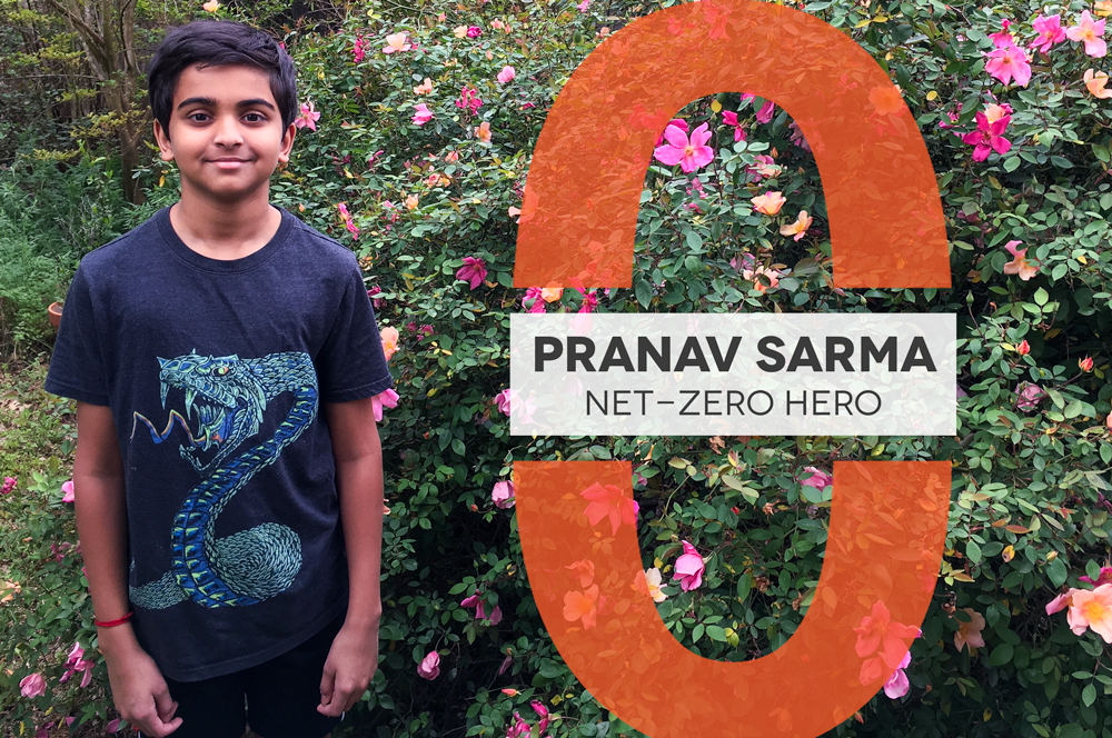 Young boy wearing a shirt with a dragon on it stands in front of a large rose bush. A graphic next to him reads "Pranav Sarma Net-Zero Hero"