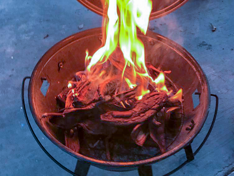 Waste material in a fire pit on fire.