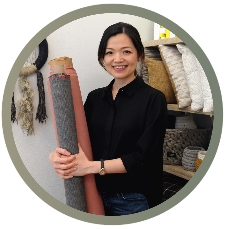 Aileen Chen holds recycled looms of fabric in her studio.